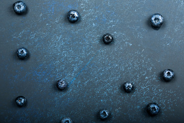 blueberry berries on a dark blue background. beautiful autumn background