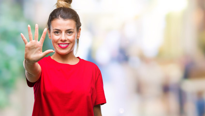 Young beautiful woman over isolated background showing and pointing up with fingers number five...