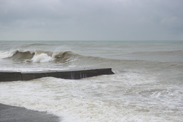 Waves on the sea near the pier overcast