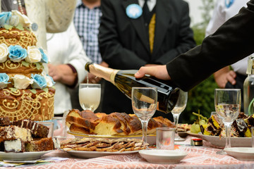 a buffet table with glasses of wine and a snack on the street