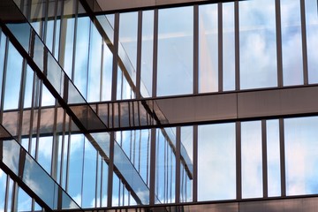 Modern building with reflected sky and cloud in glass window