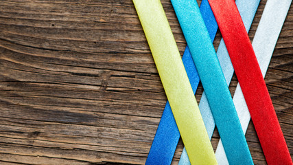 background with colorful ribbons on wood texture.
