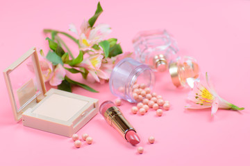 Cosmetics for makeup on pink background