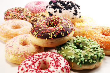 assorted donuts with chocolate frosted, pink glazed and sprinkles