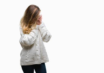 Young beautiful blonde woman wearing winter sweater and sunglasses over isolated background with sad expression covering face with hands while crying. Depression concept.