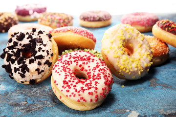 assorted donuts with chocolate frosted, pink glazed and sprinkles