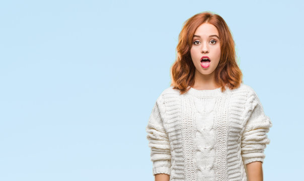 Young beautiful woman over isolated background wearing winter sweater afraid and shocked with surprise expression, fear and excited face.