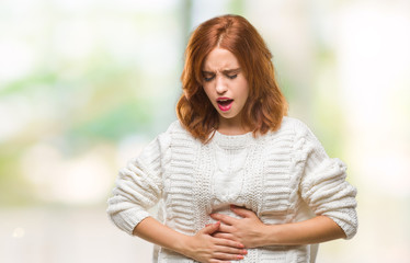 Obraz premium Young beautiful woman over isolated background wearing winter sweater with hand on stomach because indigestion, painful illness feeling unwell. Ache concept.