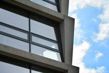 Abstract fragment of modern architecture, walls made of glass and concrete.