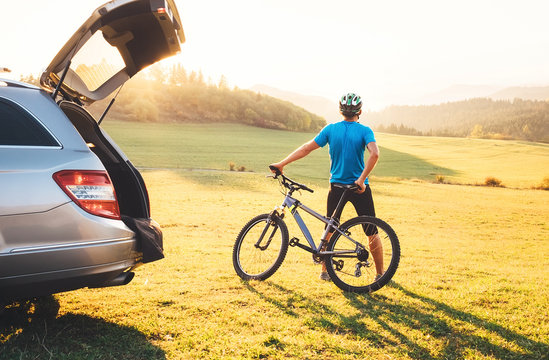 Man with bMan came by auto in mountain with his bicycle on the roof. Mountain biking concept image