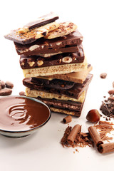 Chocolate bars on table with chocolate tower.