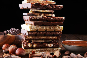 Chocolate bars on table with chocolate tower.