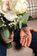 Obraz na płótnie Canvas wedding rings lie and beautiful bouquet as bridal accessories