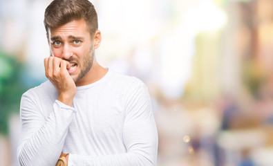 Obraz premium Young handsome man over isolated background looking stressed and nervous with hands on mouth biting nails. Anxiety problem.