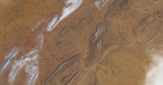 Hurtling toward earth, out of control, over desert terrain in Algeria. Vibration and camera shake. Elements of this image furnished by NASA