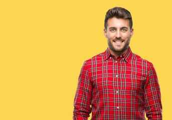 Young handsome man over isolated background with a happy and cool smile on face. Lucky person.