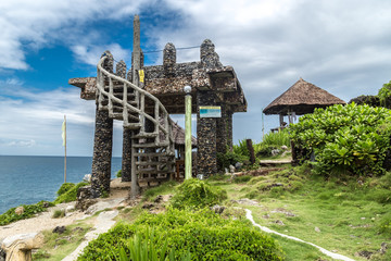 Stone building and green plants on Crystal Cove small island near Boracay island in the Philippines