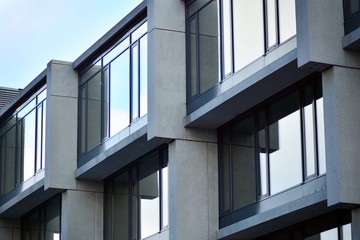 Abstract fragment of modern architecture, walls made of glass and concrete.