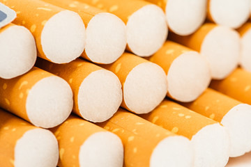 Cigarettes in a pack closeup on white background. Smoking tobacco. Bad habit.