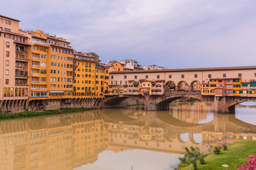 Obraz premium Colorful old buildings on the bank of Arno river in Florence, Italy Ponte Vecchio Bridge. Medieval architecture