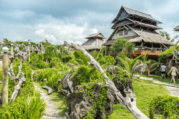 Fototapeta na wymiar Bamboo houses green plants on Crystal Cove small island near Boracay island in the Philippines