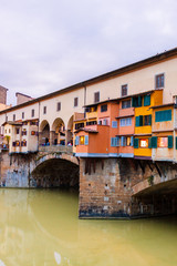 Colorful old buildings on the bank of Arno river in Florence, Italy Ponte Vecchio Bridge. Medieval architecture