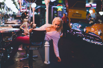 Fashion girl in a vintage cafe in the style of pin-up.