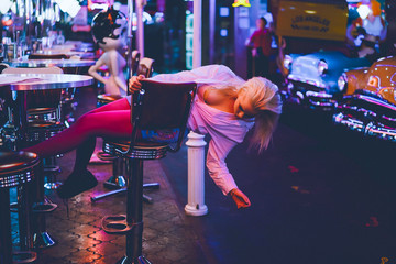 Fashion girl in a vintage cafe in the style of pin-up.