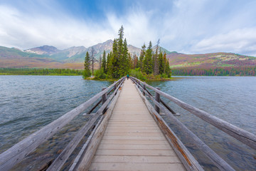 A man crossing the bridge at the Pyramid island in Alberta, Canada