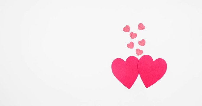 Funny red hearts meet and fall in love.  Animated footage. Romance and St Valentine day concept. 4k footage