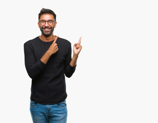 Adult hispanic man wearing glasses over isolated background smiling and looking at the camera pointing with two hands and fingers to the side.