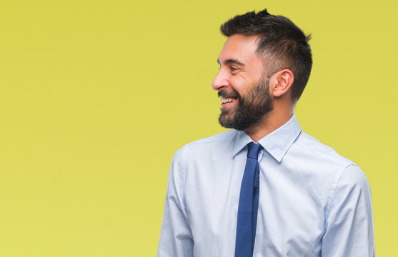 Adult Hispanic Business Man Over Isolated Background Looking Away To Side With Smile On Face, Natural Expression. Laughing Confident.