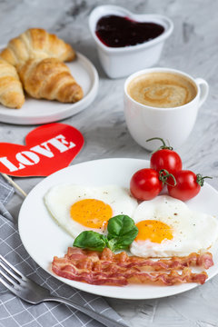 Tasty Fried Egg in the Shape of a Heart Served on a White Plate with Bacon Tomato Basil Pepper Gray Background Valentine Day Breakfast