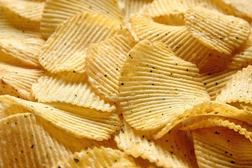 Textured background of natural corrugated potato chips