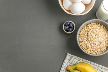 breakfast ingredients on grey background 