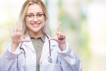 Young blonde doctor woman over isolated background showing and pointing up with fingers number...