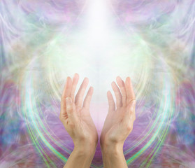 Ask Believe Receive in the Power of Love - female with hands reaching up into a white light against a beautiful angelic ethereal cup shaped background and copy space above