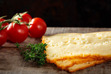Three slices of scheiben cheese with cherry tomatoes