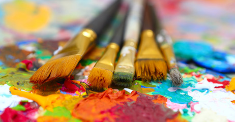 workplace painter palette with colors and brushes. Palette of colors, creative disorder, art.