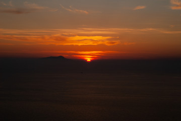 Beautiful sunset on a hot summer day, which has colored the sky and clouds