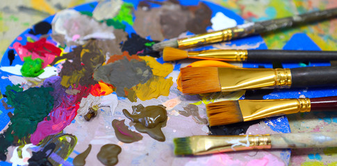 workplace painter palette with colors and brushes. Palette of colors, creative disorder, art.
