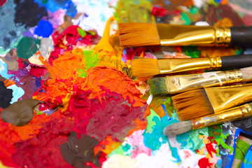 Obraz premium workplace painter palette with colors and brushes. Palette of colors, creative disorder, art.