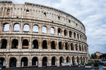 Fototapeta na wymiar Coliseum or Flavian Amphitheatre or Colosseum (Amphitheatrum Flavium or Colosseo), Rome, Italy. Cloudy blue sky