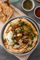 Traditional Mediterranean hummus with mushrooms and onions. Classic Hummus with paprika, olive oil, onions, mushrooms and seasonings