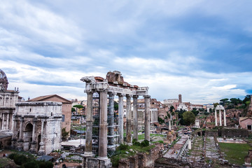 Fototapeta na wymiar Roman Forum with cloudy sky. Italy antique