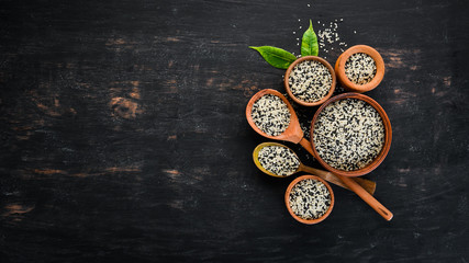 Sesame. Set of black and white sesame seeds. On a black background. Top view. Free copy space.
