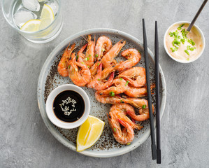Shrimp glazed in soy sauce with green onion and lemon.