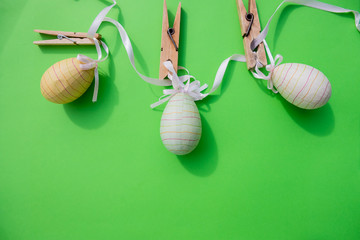 Creative Easter layout made of colorful eggs, glitter, in stripes. Flat lay background.Stylish easter eggs on green background with space for text.Happy Easter, greeting card mockup