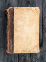 Old book with blank cover on the wooden table