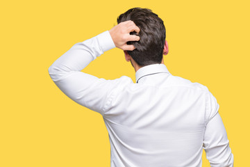 Young business man wearing glasses over isolated background Backwards thinking about doubt with...